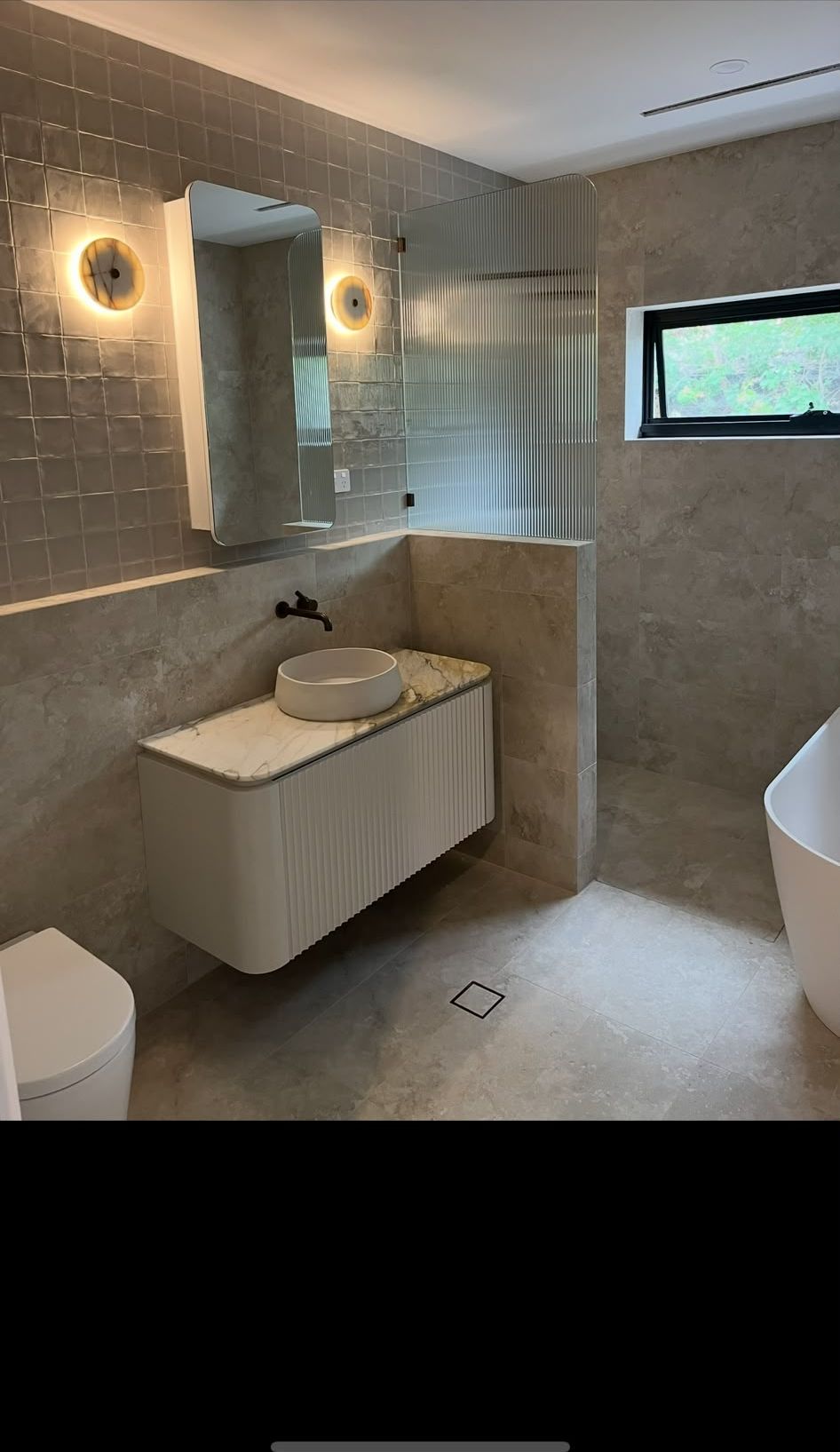 Bathroom with fluted glass shower screen, fluted vanity and marble benchtop